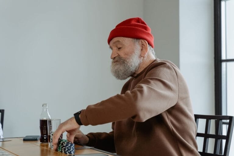Desaposentação: O Que o STF Decidiu e as Alternativas 2026 5 Senior man with beard playing poker at home, focused and relaxed.