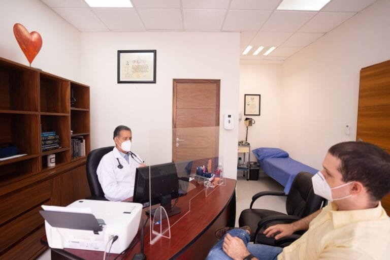 Doctor and patient with masks in medical clinic, emphasizing healthcare safety.