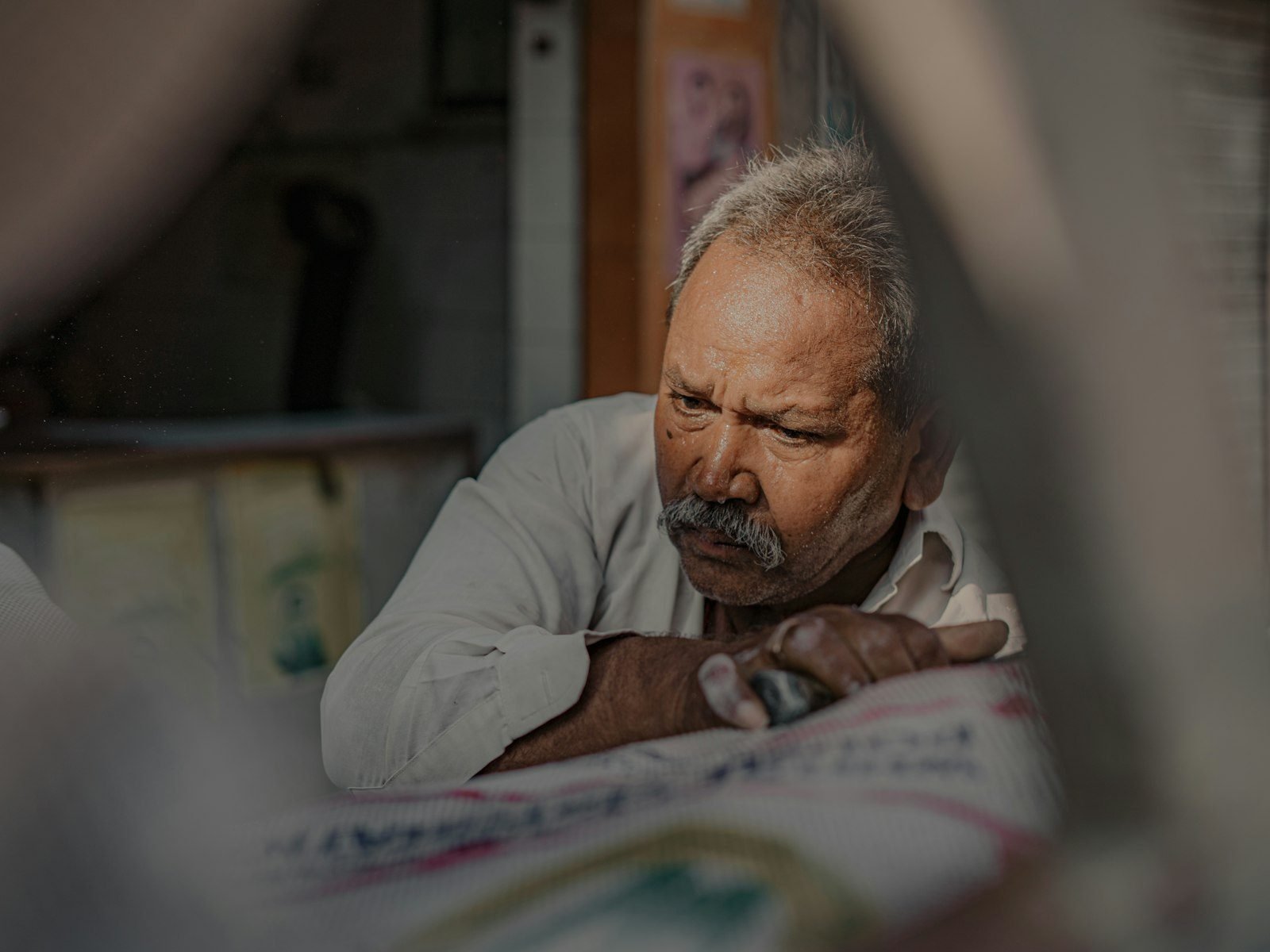 a man looking at a newspaper with a concerned look on his face