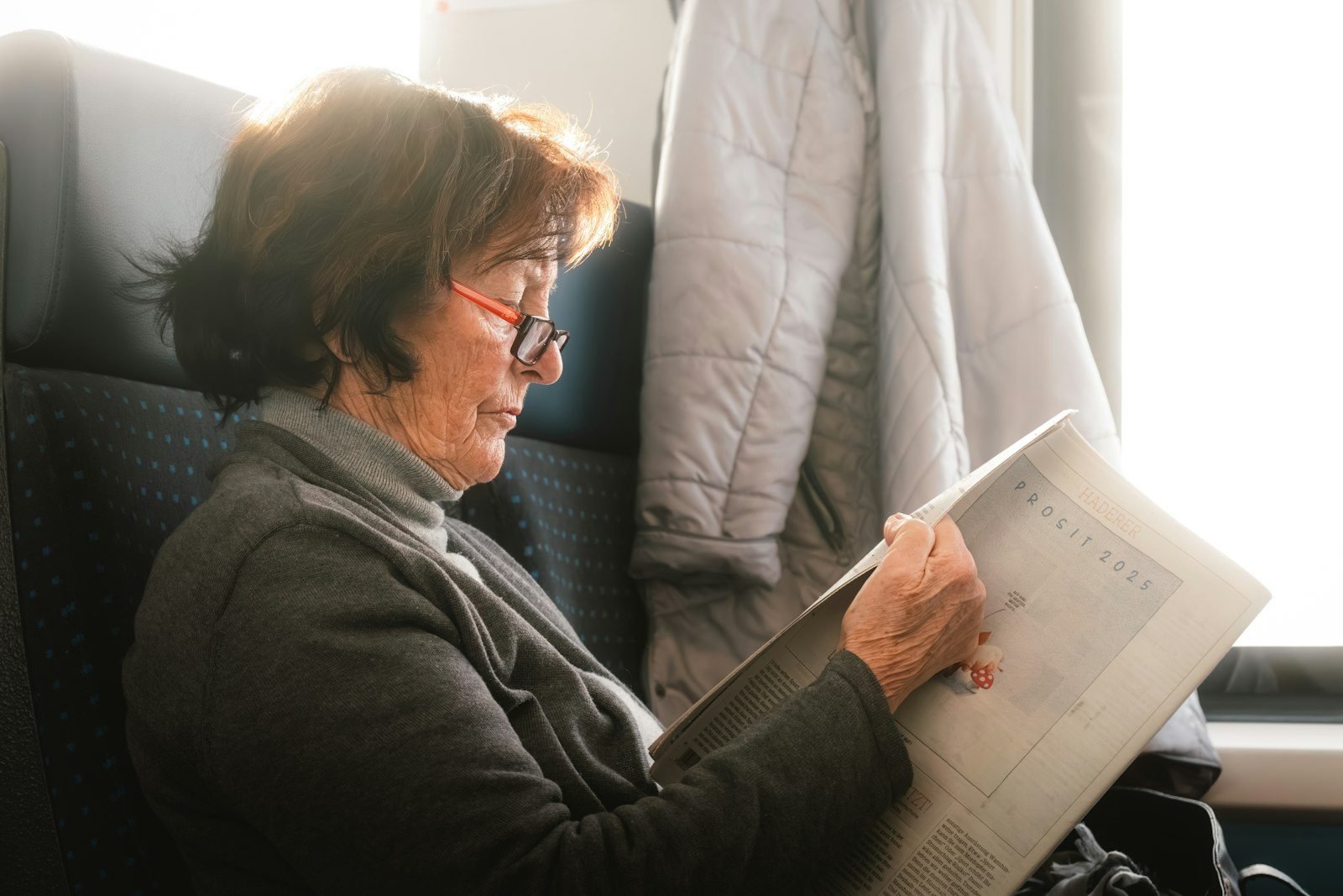 A woman sitting in a chair reading a book