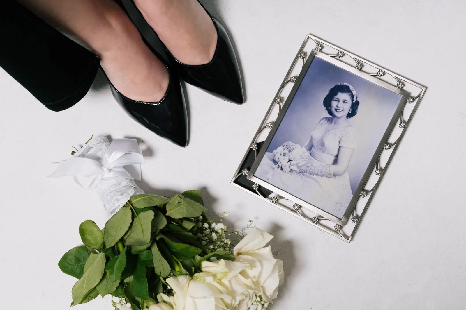 Elegant wedding image featuring black pumps and a vintage bridal portrait.