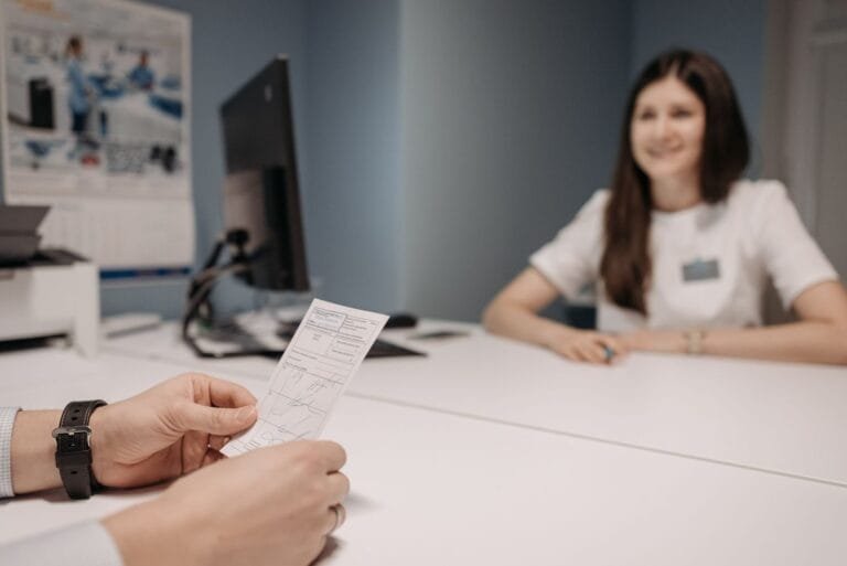 Woman doctor discussing patients prescription in a clinic office setting.