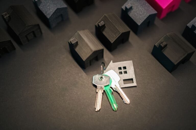 Como podemos ajudar? 3 Miniature house models and keys symbolize real estate investment and housing market.