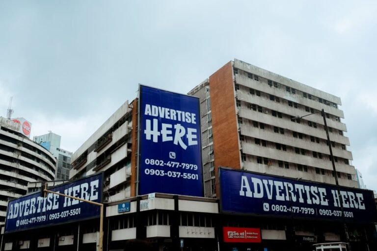 Publicidade da advocacia: os limites entre informar e captar clientela 2 Large billboards on urban buildings displaying Advertise Here in Lagos, Nigeria.
