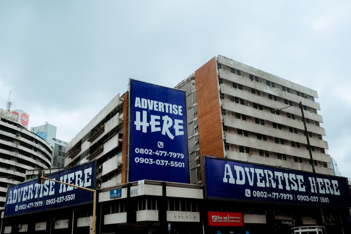 Publicidade da advocacia: os limites entre informar e captar clientela 1 Large billboards on urban buildings displaying Advertise Here in Lagos, Nigeria.