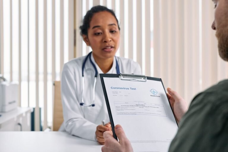 Doctor having a consultation with a patient over coronavirus test results in a medical off