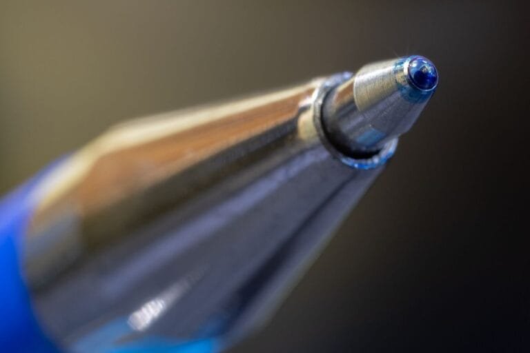 Macro shot highlighting the precision and design of a ballpoint pen tip.