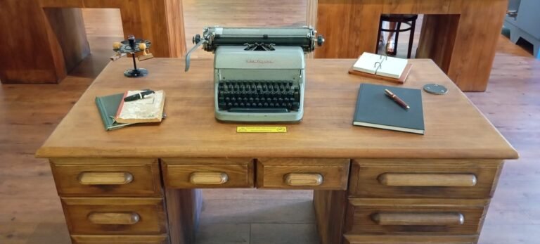 A desk with an old fashioned typewriter on it