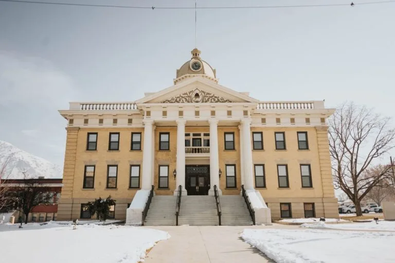 A prominent historic building in Brigham City, Utah, covered in snow during winter.