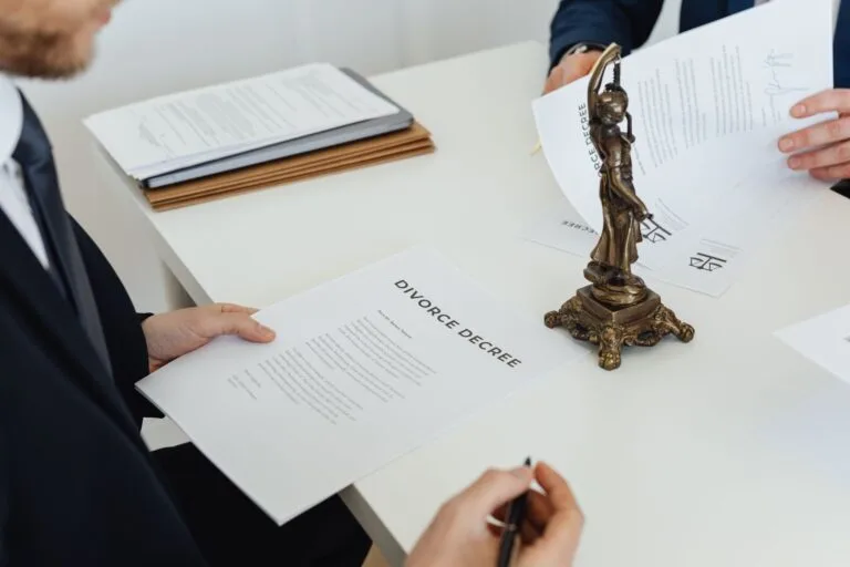 Two professionals discuss divorce decree documents, focusing on legal negotiations.