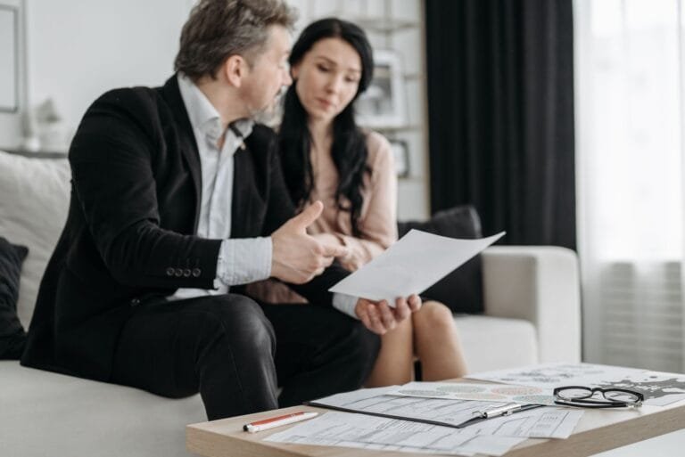 A couple discusses adoption paperwork in their living room, emphasizing their commitment a